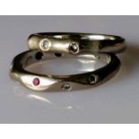 A Jeremy Hoyle carved 18ct white gold ruby and diamond eternity ring, size K and another similar