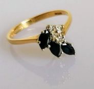A 9ct yellow gold, diamond, and sapphire ring, set with three marquise-cut dark blue sapphires and