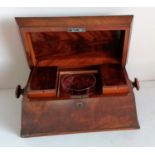 A Georgian mahogany sarcophagus tea caddy with shaped top, fitted interior with etched glass