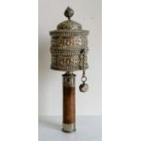 A Tibetan silver prayer wheel, with a bamboo handle, 26 cm long