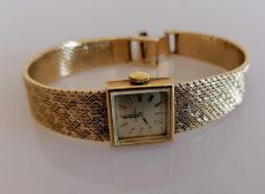 A mid-century ladies 9ct gold Omega manual bracelet watch with square champagne dial, 14mm, raised