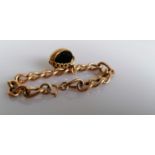 A George V curb link bracelet with swivel bloodstone fob, hallmarked, 17 cm, each link stamped