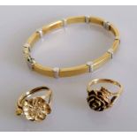 Two stylized floral 9ct yellow gold rings, sizes J, N, and a bangle with white gold accents, 6 x 5