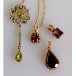 An Edwardian peridot and seed pearl pendant on a gold chain, a teardrop garnet pendant on chain, one