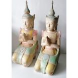 A pair of painted wood carved Oriental kneeling buddha figurines, each 54 cm H, some paint peeling