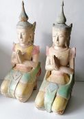 A pair of painted wood carved Oriental kneeling buddha figurines, each 54 cm H, some paint peeling