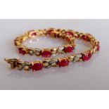 A garnet and diamond line or tennis bracelet on 9ct yellow gold, hallmarked, 18 cm, 8.55g