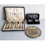 A George V cased set of six silver coffee spoons and tongs with rococo decoration to terminals by