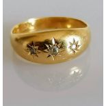 An 18ct yellow gold gypsy ring with three inset diamonds, size N, 2.67g