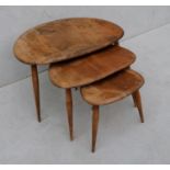 A nest of 3 Ercol elm and beech pebble occasional tables, middle table cracked, all with stains