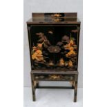 A Meiji period lacquered cabinet with Shibayama inlaid decoration, twin doors revealing a shelved