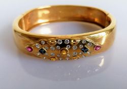 A multi-stone cushion-shape hinged bangle with two square mixed-cut sapphires, each 2.9mm x 2.9mm, a