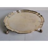 A Georgian-style silver salver with pie crust decoration on four leaf scroll feet by Sanders &