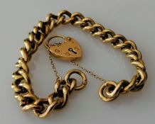 A 9ct yellow gold curb link bracelet with padlock clasp and safety chain, hallmarked, 34g