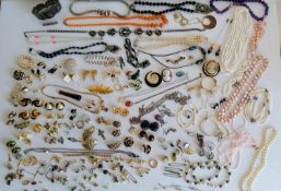 A large assortment of mixed costume jewellery to include pearls, beaded necklaces, rings,