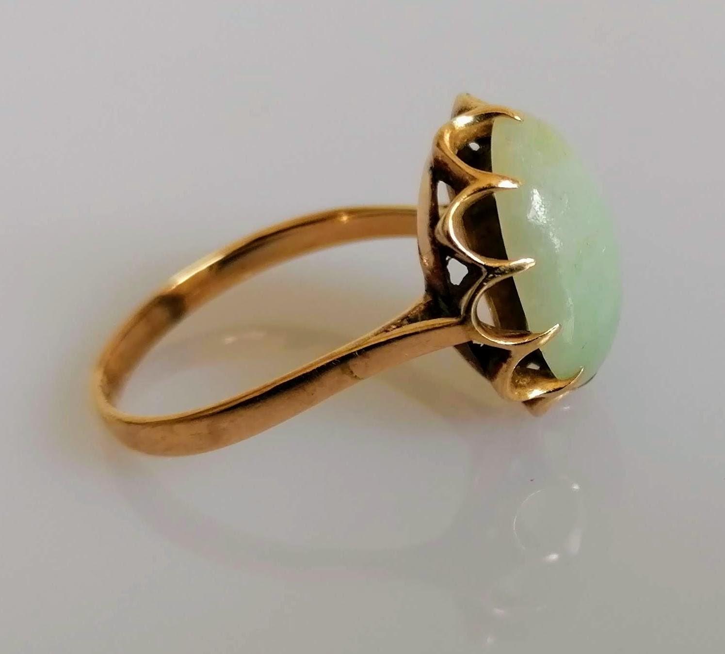 A 9ct yellow gold ring with an oval jade cabochon 15mm x 11mm in a claw setting, size S, marks - Image 2 of 3