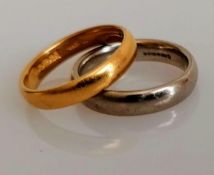 A 22ct yellow gold wedding band, 4.26g and a white 18ct gold wedding band, both size L and