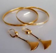 Two bangles and a pair of earrings, both unmarked, testing for high quality gold, 24g (3)