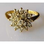An 18ct yellow gold diamond cluster ring in a tiered claw setting, the nineteen brilliant-cut
