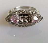 An 18ct white gold, diamond, and kunzite dress ring, the marquise-cut pale lilac kunzite set