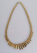 A 1970's 9ct yellow gold necklace with graduated flutes, 42 cm, hallmarked, 12.8g