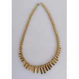 A 1970's 9ct yellow gold necklace with graduated flutes, 42 cm, hallmarked, 12.8g