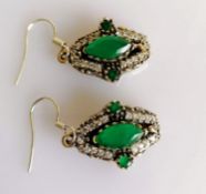 A pair of Art Deco marquise-cut emerald earrings on a silver frame with zirconia decoration, each