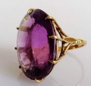 An oval amethyst dress ring in a 9ct gold basket setting, stamped, size N, stone 27mm x 20mm, 11.24g