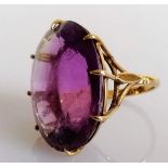 An oval amethyst dress ring in a 9ct gold basket setting, stamped, size N, stone 27mm x 20mm, 11.24g