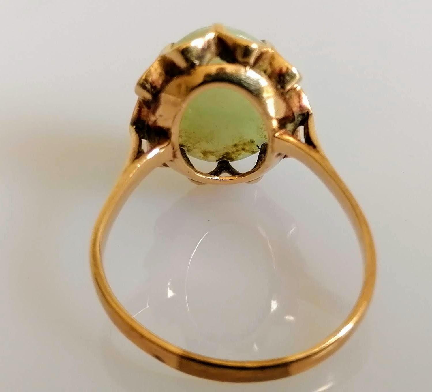 A 9ct yellow gold ring with an oval jade cabochon 15mm x 11mm in a claw setting, size S, marks - Image 3 of 3