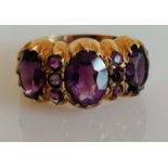 A mid-century 9ct yellow gold three-stone amethyst dress ring, largest 10mm x 8mm; 8mm x 5mm
