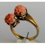 A mid-century carved coral crossover ring on a 9ct yellow gold shank, size N, hallmarked 4.14g