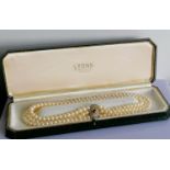 An Art Deco-style three-row cultured pearl necklet on an 18ct white and yellow gold lozenge-shape