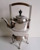 A Victorian silver tea kettle with gadroon decoration, urn finial (slightly damaged) on a conforming