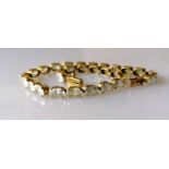 A 14ct yellow gold line or tennis bracelet with cubic zirconia decoration, box clasp, 20 cm,