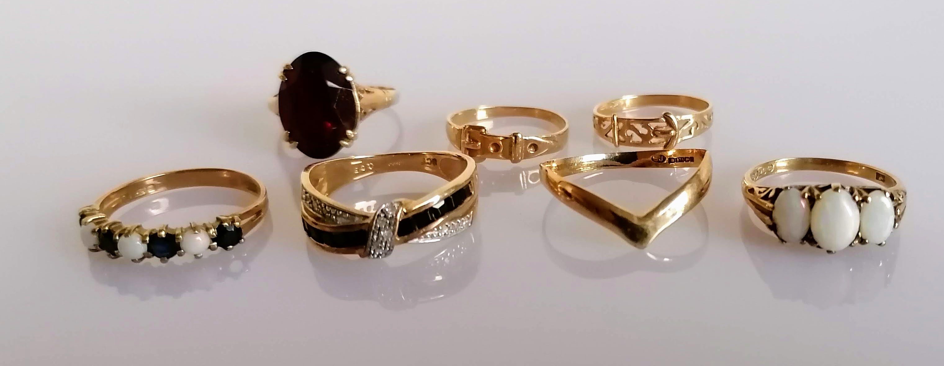 An assortment of seven yellow gold rings, some gem-set, all hallmarked or stamped 9ct, various sizes