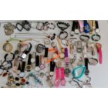 A large assortment of fashion watches and some costume jewellery, etc