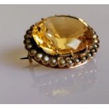 A late Victorian oval citrine brooch with seed pearl decoration, approximately 7.50 carats, stone