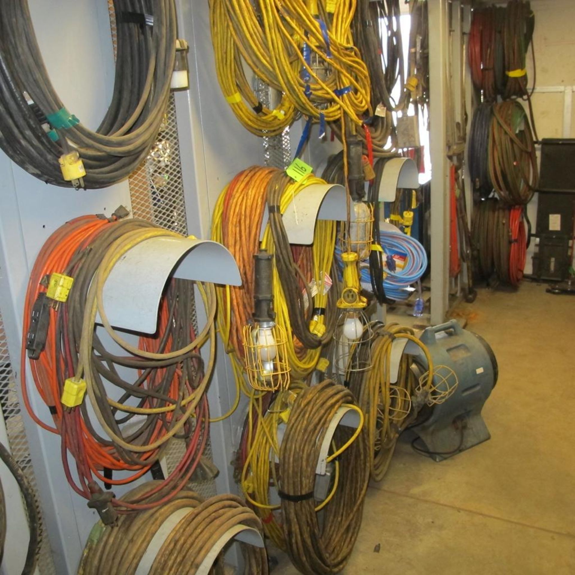 LARGE LOT OF POWER CABLES, EXTENSION CORDS, LAMPS ON 9 HOLDERS IN CAGE (IN WEST BLDG)