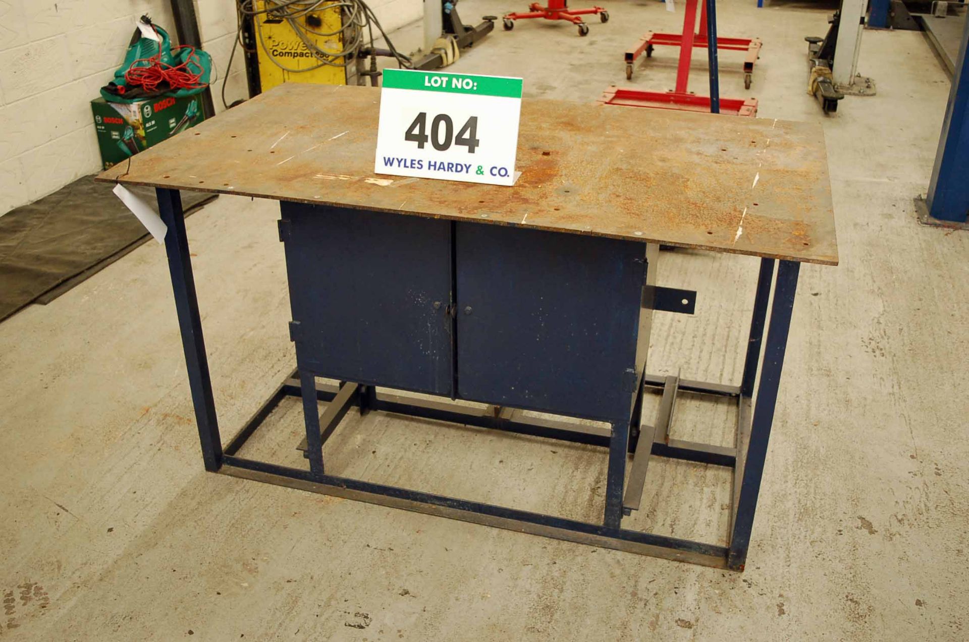 A 1.5M x 870mm Blue Painted Heavy Steel Plate Topped Fabrication Workbench with fitted Double Door