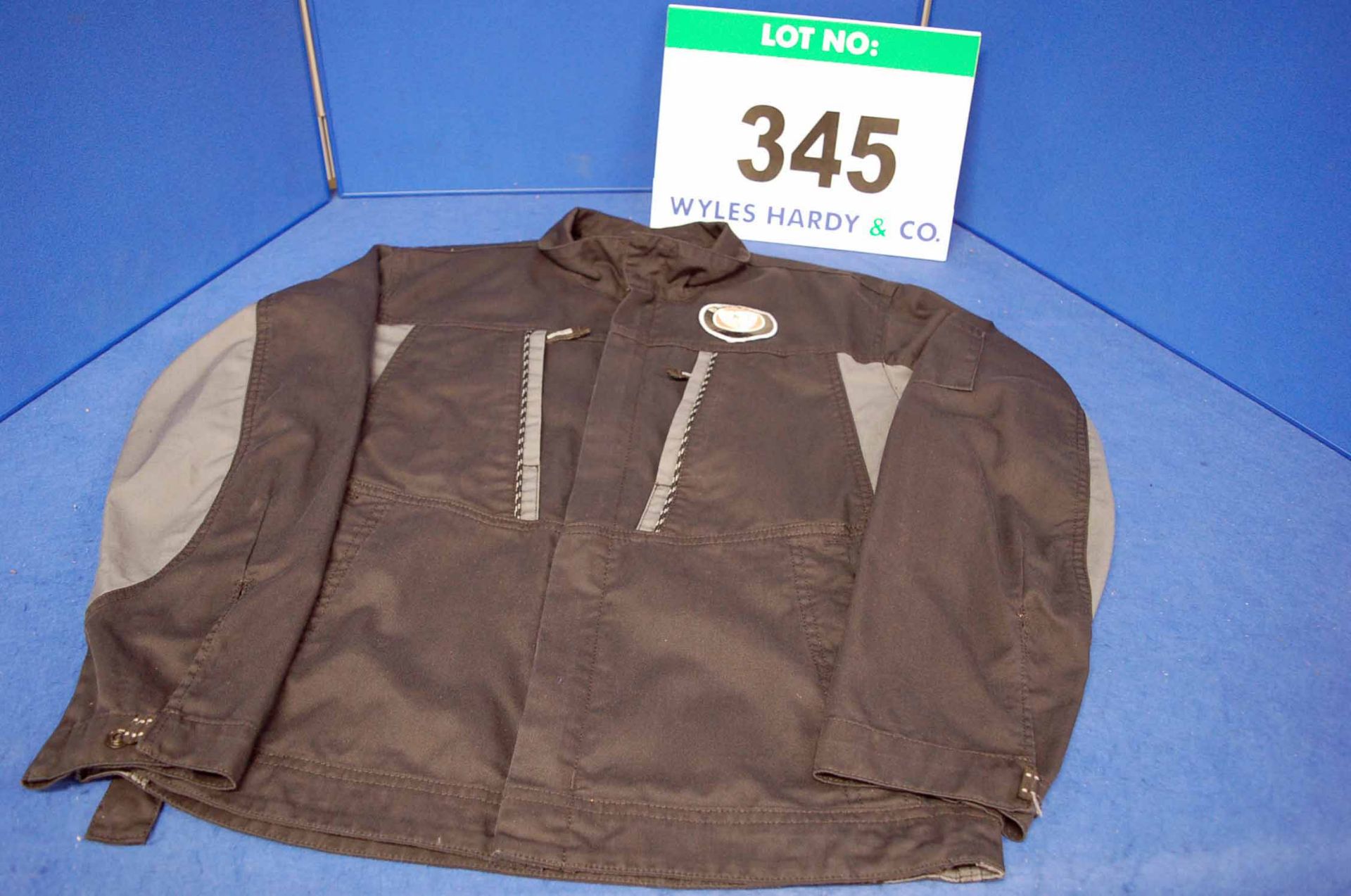 A Used Black and Grey Cotton Mechanics Jacket with Bristol Badge on Upper Left Chest Panel with