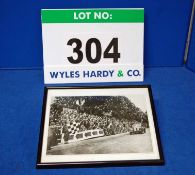 A Framed and Glazed Photograph showing a Bristol 400 Approaching the Chequered Flag at Speed