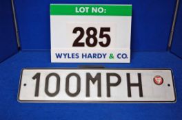 A 100 MPH Number Plate Formed of Numbers and Letters Stamped into An Alloy Plate and Painted Black