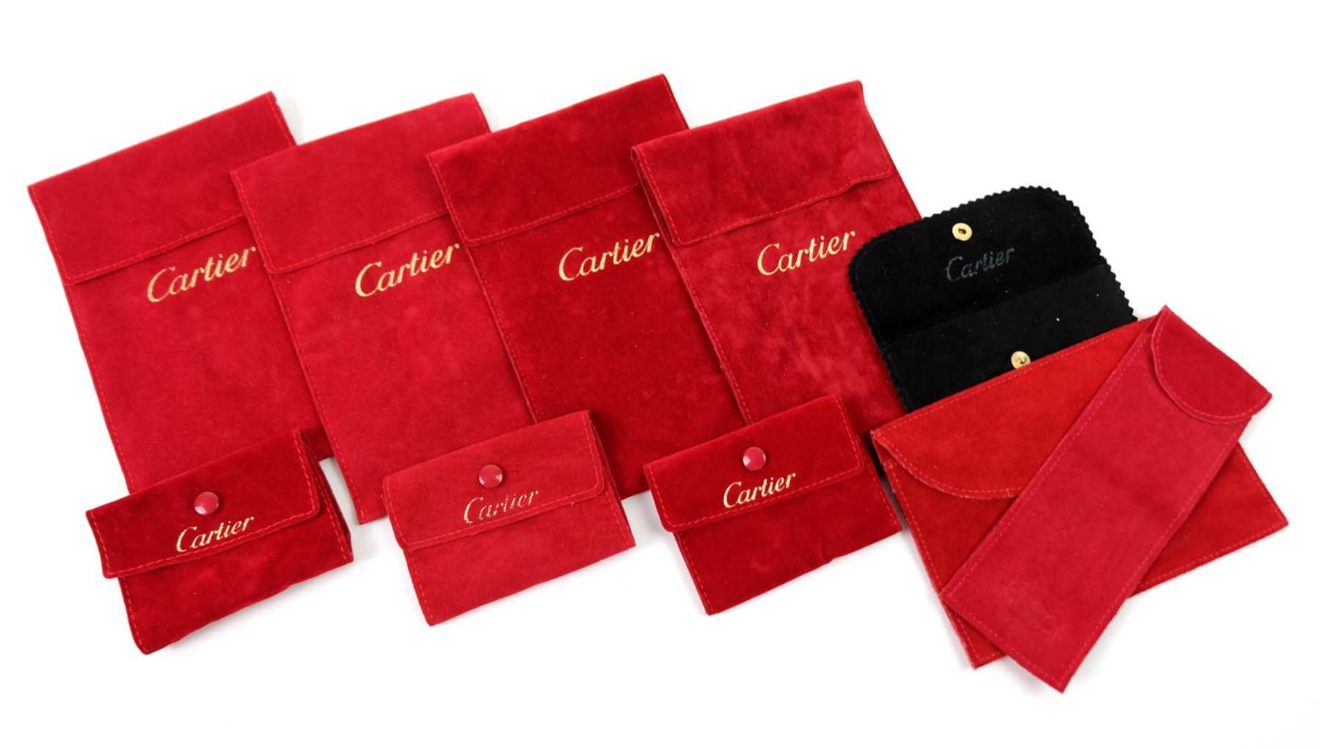 HÜLLEN/ SCHMUCKTÄSCHEN, Sammlung von 8, Cartier, roter Stoff, Gold geprägt bzw 1x schwarz, 4x