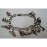 Silver charm bracelet with 11 charms, 30 grams Approx 30 grams