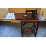 C B Jones sewing machine in its original table, in working order (the leather strap is split but