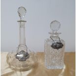 2 cut-glass decanters, 1 a ships decanter, together with 2 unmarked white metal decanter labels, 1