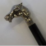 Unmarked, white metal horses head & ebonised wood walking stick with a white metal unmarked tip. The