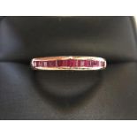 Unusually shaped 9ct yellow imported gold band ring set with 12 square cut rubies Approx 1.5 grams
