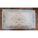20thC blue & cream patterned rug with tassels, 122 c 216 cm